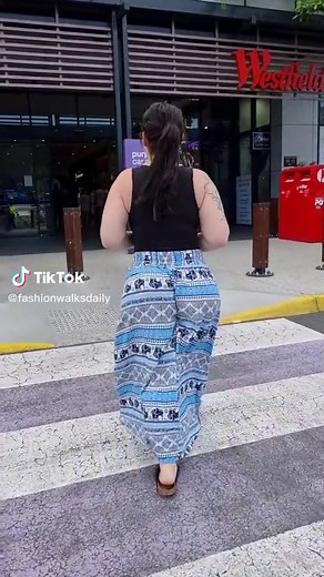 Urban Walkthrough: Woman in Stylish Blue and White Skirt