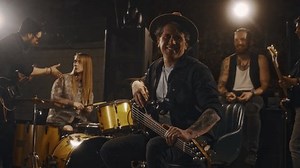 clip-3610322319-portrait-smiling-mature-caucasian-man-electric-guitar