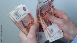 Close-up of hands counting five-thousandth banknotes of the Russian ruble. Men's hands count Russian money 5000 banknotes. business, finance