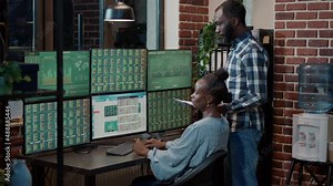 Work colleagues brainstorming ideas to sell trade stocks from stock market hedge fund. Using multiple monitors to analyze forex exchange profit and statistics, monitoring sales numbers.