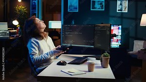 Freelancing programmer listening music while designing and developing software applications. IT specialist wearing headphones, implementing and maintaining company systems, camera B Stock Video