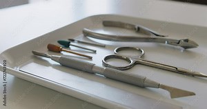 Professional manicure instruments on white table in beauty salon ready for use. Necessary tools for making clients nails well-groomed and ready for covering with polish. Nail care tools