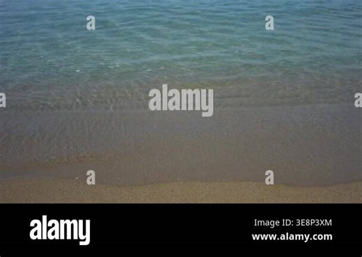 Sea waves washing over sandy beach with crystal water Stock Video Footage - Alamy
