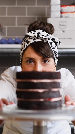 ANNA Cake Couture on Instagram: "It’s not an ANNA cake until it passes the final inspection ✨ Four layers of chocolate sponge and layers of raspberry buttercream, stacked tool and perfectly straight. We don’t do wonky cakes around here! Ready for its crumb coat."