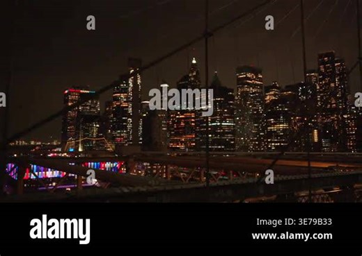 Night skyline framed by Brooklyn Bridge cables and tower New York Stock Video Footage - Alamy
