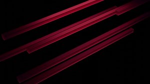 Abstract diagonal movement of colorful bars isolated on a black background. Design. 3D stripes moving into the same direction.