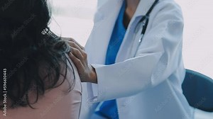 Doctor use stethoscope, checking up heart beat, auscultation in doctor office at hospital. Patient worker has to get medical checkup every year for her health or medical checkup cardiologist.