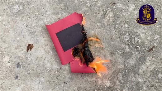 Powell Academy students officially declared the 2025 Atlantic hurricane season over by burning warning flags made earlier in the school year. The flags were set on fire by the head teacher of the academy, with third grader Munro and kindergartener Georgia leading the tradition. | Andrew Powell | Facebook