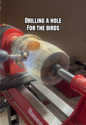 Wood Turning a Pine Log birdhouse on a wood lathe. Drilling a hole for the birds to enter the birdhouse. #Woodturning #woodlathe #birdhouse