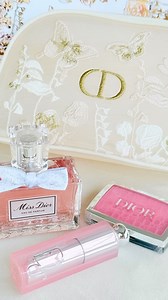 Miss Dior Mothers Day 2025. This is a gorgeous embroidered pouch with a CD zipper pull. The boxing is stunning as well. If you’re a collector this is a must have. Butterflies roses and embroidered absolutely beautiful. Miss Dior Eau de Parfum, 50 ml. The eau de parfum, a promise of happiness. A bouquet with accents of lily-of-the-valley, peony and iris that are brought to life with notes of Centifolia rose. - Dior Addict Lip Glow, shade 001 Pink. The colour-reviving lip balm that hydrates lips t