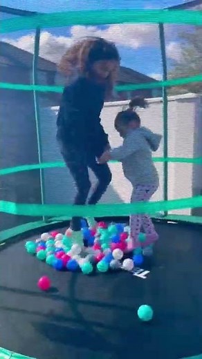 Girls Jumping on Trampoline with Balls