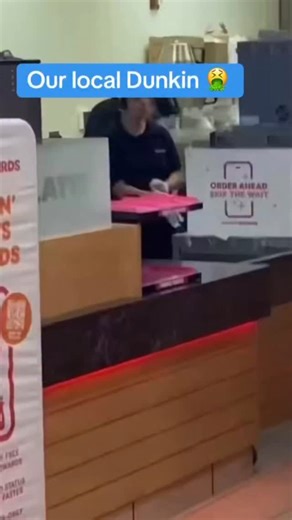 #CaughtOnCamera: A customer at a Dunkin’ in Crofton, MD captured a disturbing moment showing an employee sitting on a food prep counter and clipping his toenails behind the counter during a shift, raising serious food‑safety concerns. The clip went viral on social media, prompting community outrage and discussions about hygiene in food service environments. Critics pointed to the video as an example of why strict sanitation standards matter in restaurants. | The DMV Daily