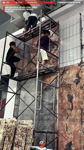 Process Worker Installing Giant Natural Stone Panels Using A Precision Lifting System