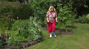 Senior woman with broken ankle uses crutches