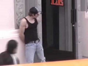 Man standing around in Torn Jeans