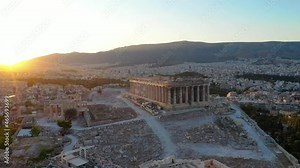 Greece Acropolis city of Athens parthenon, Mount Lycabettus, Parliament Building and residential buildings in summer. Ancient greek temple ruins of Erechtheion. Aerial shot. . Beautiful sun rays.