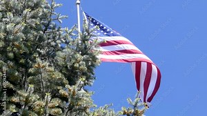 American flag flying proudly against a brilliant blue sky.