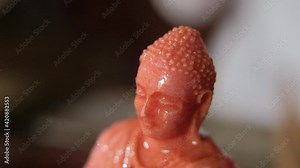 A tea master watering a buddha statue in a classic authentic Chinese tea ceremony. Authentic tea paraphernalia. Slow-mo