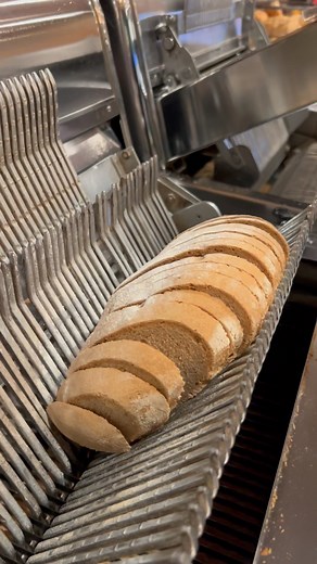 1.7K views · 1.8K reactions | As satisfying as it gets ‍♀️ We bake and slice our breads fresh daily. Come in and grab your own for the best bread you’ve eaten! . . #oddlysatisfying #woah #viral #bread #howto #slicedbread #asmr #beach #deli #german #baking | GermanDeli.com | Facebook