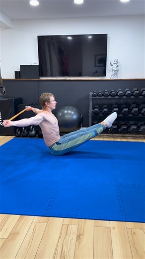 Get Gymnast Fit on Instagram: "Holding the legs off the floor builds hip flexor strength and deep core stability. At the same time the torso must stay tall and steady while the arms move the stick in full circles. This is a shoulder dislocation drill, so the stick travels all the way around the body without letting the ribs flare or the pelvis tilt. The goal is to keep the lower body still and let the shoulders move freely, teaching clean separation between core control and arm mobility. #coretr