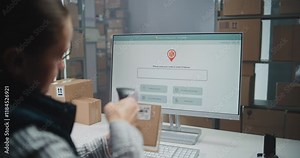 Female Postal Warehouse Employee Scans Code on Cardboard Box with Barcode Scanner, Monitors Package Information. PC Screen Shows Delivery Tracking Software to Check Parcel Routing. Dolly Shot Close Up