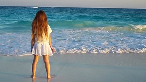 Adorable little girl at beach during summer vacation