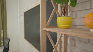 Junior school children in classroom on science chemistry lesson. Teacher talks to kids, test tubes with liquid on the desk, view of the room. Slow motion.