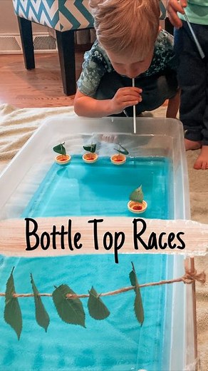 Brittany | Kids/Toddler/Baby Activities on Instagram: "Stuck inside? Create a boat race! Blowing through a straw is a great way for kids to strengthen their muscles in their jaw and mouth. For this activity, the little boats are made of bottle tops, playdough, toothpicks, and leaves (boats inspired by @beafunmum ). The container is filled with water and blue food coloring. The race finish line is made of leaves, bamboo skewers, and twine. To play, blow through the straws to make the boats move. 