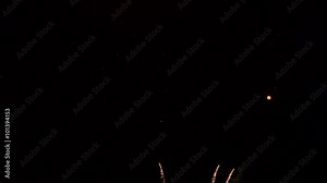 Multiple fireworks blast and explosions against night sky. Aerial at night during celebration
