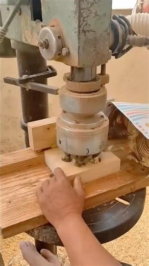 Industrial multi spindle drill press creating multiple holes in a wooden block