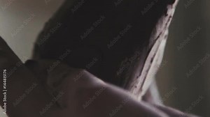 Artist modeling a clay human figure. Craftsman artist making craft, pottery. Process of making a clay figure. Clay figure is an antique man. Close-up: a sculptor's stack. Tool for processing clay