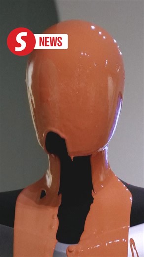 Activists pour orange liquid over robot at Elon Musk's Tesla store in London