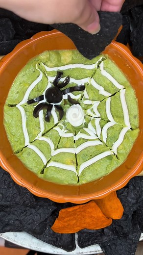 Spider Web Guacamole 🥑 The perfect easy appetizer or snack idea for your Halloween spread! Feel free to make your own guacamole or use store bought. Just make sure the top is smooth (use a spoon to flatten) Add sour cream to a piping bag or squeeze bottle and make rings on the top of the guacamole. Use a toothpick to stretch out the lines. The spider is made from an olive 🫒 Enjoy! #guac #guacamole #halloweenideas #halloweenfood #festive #holidayfood #easyrecipes #easymeals #fun #spooky #spooky