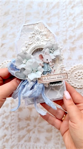 Olga Biel • handmade cards and albums • UGC UK/ PL on Instagram: "Join me in making a cute, baby’s tag- card from the Baby collection by Stamperia💙 For this card, I made the base myself. I used texture paste, embossing powder, and a mask. I created 3D compositions using handmade flower ribbon and gorgeous graphics. Finally, of course, I had to add glitter from @wowembossing 💙 ribbons from @old_fashion_ribbon 💙 This card would be perfect for every baby’s occasion: a first birthday, for newborn