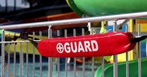 Lifeguard red sign by pool. Safety of children and adults in pool in water park