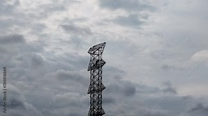 Electric tower construction, workers climbing poles. dangerous engineering work. View of a steel erector worker strengthening a power line pole. Electric transmission towers that support high voltage.