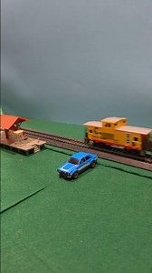Hot Wheels cars crashes into train station after a collision with a model train #hoscale #hotwheels