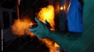 Muscular athlete treats hands with talcum powder and clapping before workout in gym ready for bodybuilding strength exercise slow motion close up
