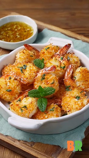 Baked Coconut Shrimp Golden and crisp, these baked coconut shrimp shimmer with sweet tropical flakes and a whisper of spice. Each bite captures the essence of coastal indulgence, light, fragrant, and irresistibly tender within its golden shell. Ingredients: 1 pound large shrimp, peeled and deveined 1/3 cup cornstarch 1 teaspoon salt 3/4 teaspoon cayenne pepper 2 cups flaked sweetened coconut 3 egg whites How to Make It: 1. Prepare the Shrimp: Rinse and pat the shrimp dry with paper towels. Prehe