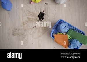 Close up of a professional cleaner hands wearing yellow rubber gloves wiping the floor with a cloth and detergent spray, concept of deep home cleaning and professional housekeeping services. top view Stock Video Footage - Alamy