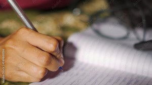 Teenager college student girl writing in notebook with pen. Teen girl school student making notes in copybook. Stock Video