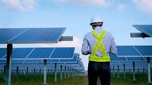 Electrical engineer survey, checking, maintenance electric system at sunset solar panel field. 4K