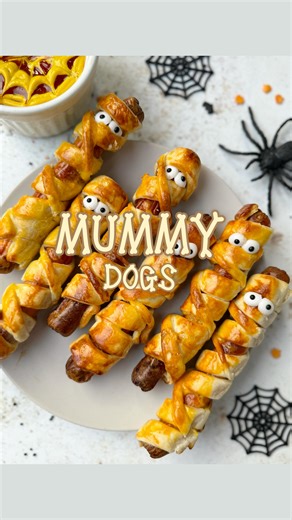 Jen Fox | Easy Recipes on Instagram: "Follow @foxnestfood for more easy recipes.. It’s that time again..👻 Airfryer Mummy Dogs With a spider cobweb dip It’s Spooky season and this is my kids favourite treat/snack! So easy and simple to make. Save this easy and fun recipe 👻 What you need: - 10 Frankfurters / or Veggie Alternative - 1 sheet of ready made puff pastry - Edible Eyes (mustard can be used too!) - Ketchup & Mustard - 2 egg yolks beaten wash to brush pastry (milk can be us