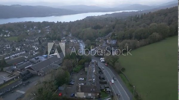 Drone flying over Windermere town with Lake Windermere in distance
