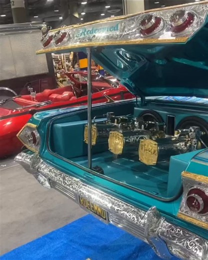 The video opens with a classic Chevy lowrider, paint shining under the light, every flake and pinstripe catching the light. Hydraulics hiss as the front end lifts, then drops, bouncing in rhythm while old-school music plays in the background. Chrome wire wheels roll smooth, whitewalls clean, and the interior shows off velvet seats and a detailed dash, nodding and filming. #impala #lowrider #lowriders | The Lowriders