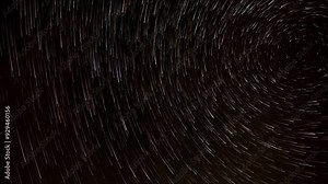Time lapse looking up into the night sky at the north star, Polaris, and the stars spinning around it with comet like tails. Only stars are included in the clip.