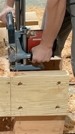 Cutting timber in a waterfall of sawdust at our Lehi shop | Western Timber Frame