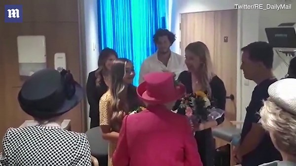 Queen plants tree during visit to Agricultural Botany institute