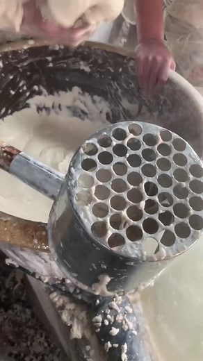 Traditional Food Preparation with Sieve and Pestle