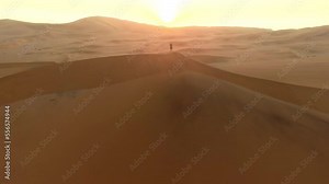 Drone, desert and man walking, sand hills and landscape dunes, freedom and holiday travel in dry land in Namibia. Male walk, vacation or adventure with horizon, traveling and aerial view in nature
